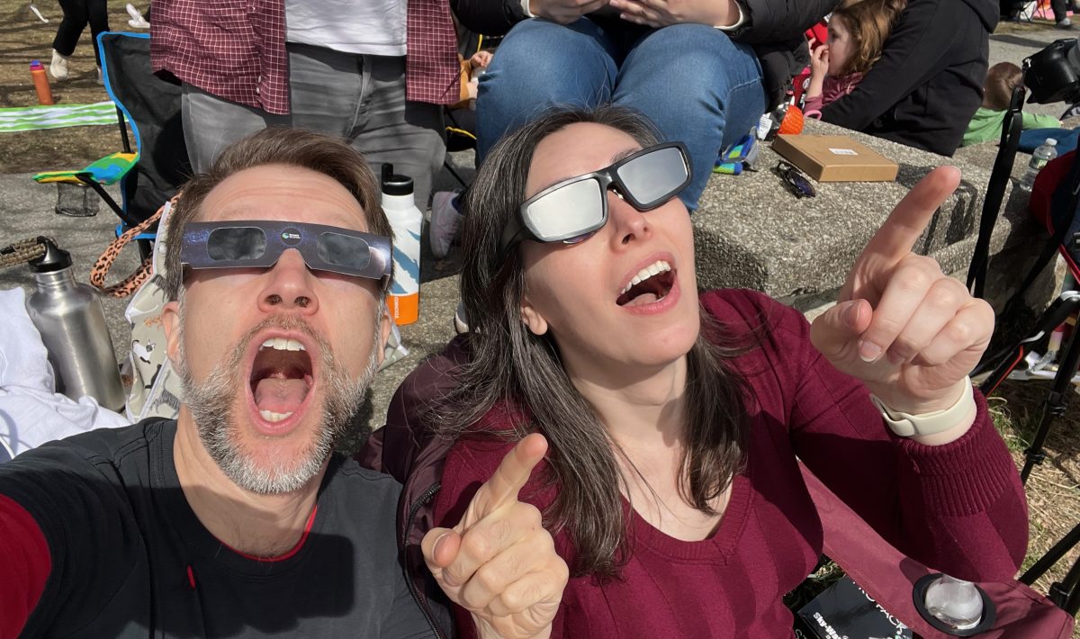 A selfie of Ken and Jess looking up in mock shock and awe at the partial eclipse
