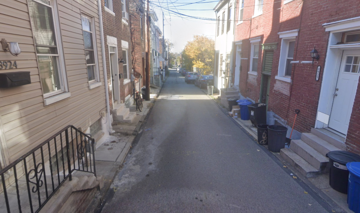 A narrow alley of a street with apartments on both sides